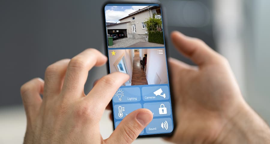Homeowner checking surveillance camera feeds on a cell phone