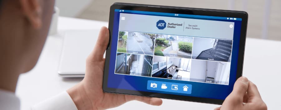 Homeowner watching surveillance streams on a tablet